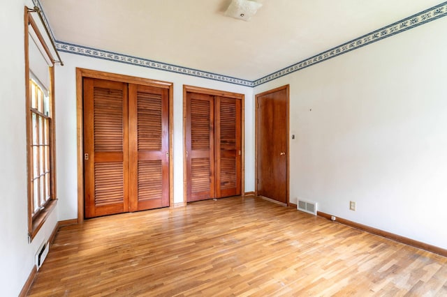 2814 Lakeview Dr, Fergus Falls, MN 56537 - unfurnished bedroom with two closets and light wood-style floors