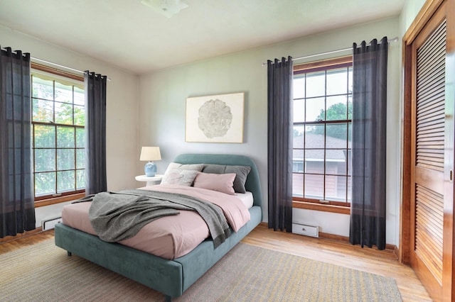 2814 Lakeview Dr, Fergus Falls, MN 56537 - bedroom with wood finished floors, a baseboard heating unit, and a closet