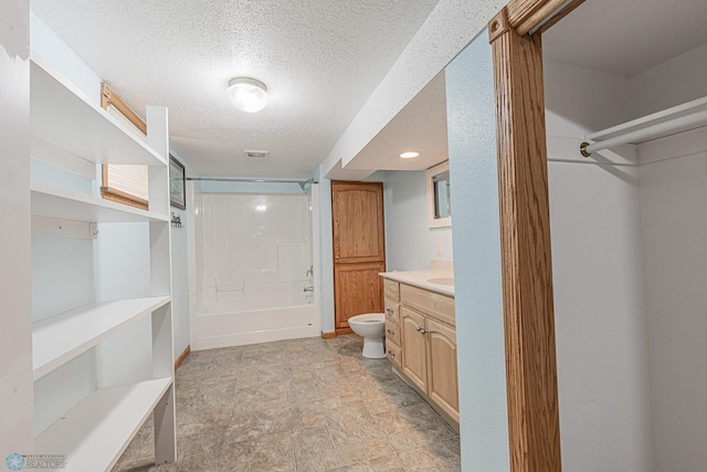 1023 12th St N, Fargo, ND 58102 - full bath featuring vanity, a textured ceiling, tub / shower combination, and stone finish flooring