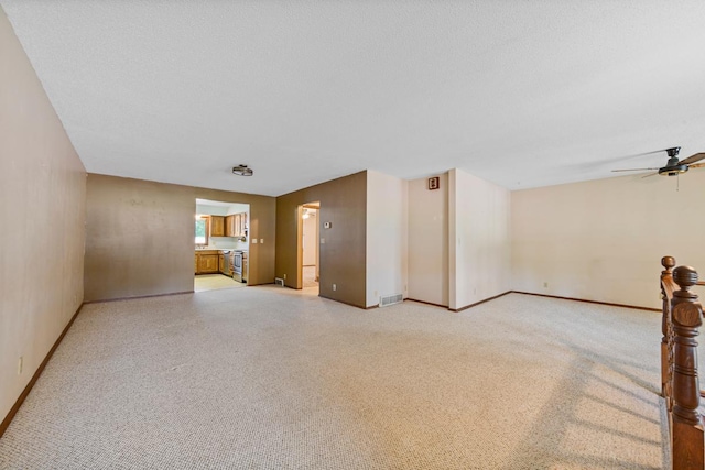 635 5th St, Windom, MN 56101 - unfurnished living room featuring light carpet and ceiling fan