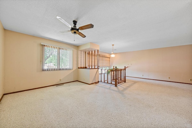 635 5th St, Windom, MN 56101 - empty room featuring a ceiling fan, carpet, and a textured ceiling