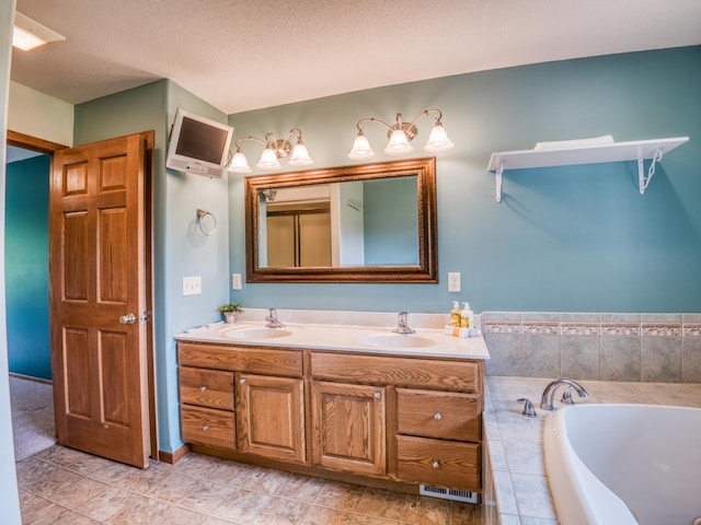 22152 Polaris Rd NW, Puposky, MN 56667 - bathroom featuring double vanity, a garden tub, a textured ceiling, and tile patterned floors