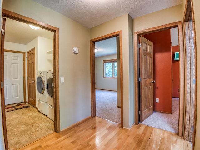 22152 Polaris Rd NW, Puposky, MN 56667 - laundry room with independent washer and dryer, light wood-type flooring, and a textured ceiling
