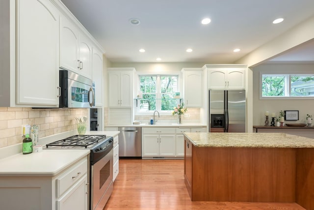 3543 Eben Way, Stillwater, MN 55082 - kitchen with appliances with stainless steel finishes, healthy amount of natural light, a sink, light wood-style flooring, and recessed lighting
