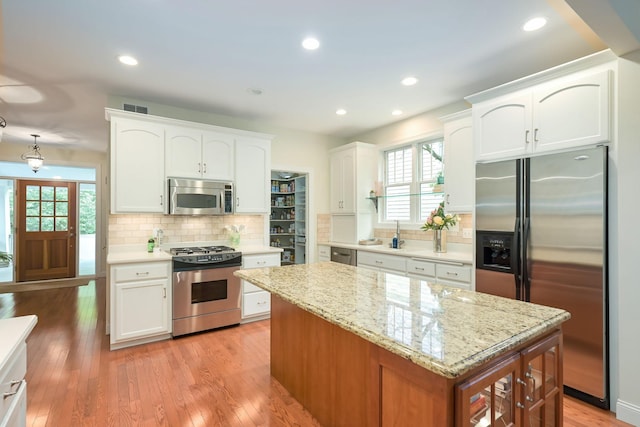 3543 Eben Way, Stillwater, MN 55082 - kitchen featuring stainless steel appliances, plenty of natural light, white cabinets, backsplash, and recessed lighting