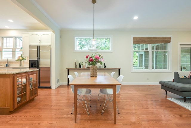 3543 Eben Way, Stillwater, MN 55082 - dining area with crown molding, baseboards, healthy amount of natural light, light wood-type flooring, and recessed lighting