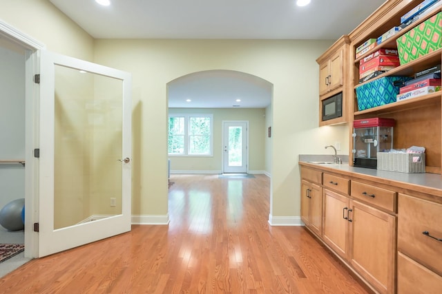 3543 Eben Way, Stillwater, MN 55082 - kitchen with arched walkways, recessed lighting, open shelves, light wood finished floors, and black microwave