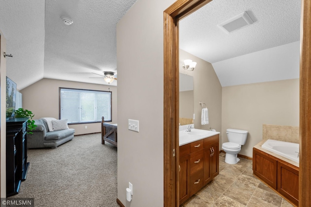 5261 Fenson Ct N, Hugo, MN 55038 - bathroom with lofted ceiling, a textured ceiling, vanity, a garden tub, and ceiling fan