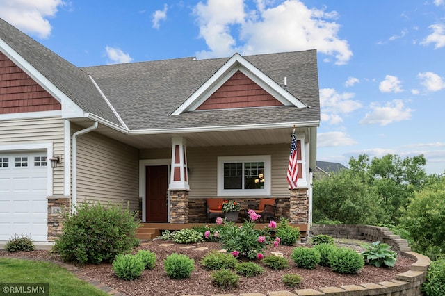 5261 Fenson Ct N, Hugo, MN 55038 - craftsman inspired home featuring a shingled roof, covered porch, stone siding, and an attached garage