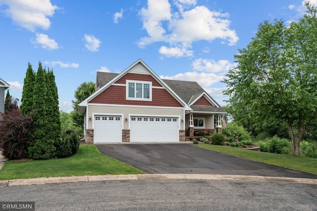 5261 Fenson Ct N, Hugo, MN 55038 - craftsman inspired home featuring stone siding, driveway, a front lawn, and a porch