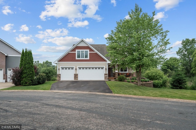 5261 Fenson Ct N, Hugo, MN 55038 - craftsman-style house with stone siding, asphalt driveway, a garage, and a front lawn