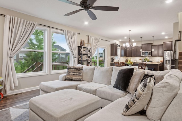 17552 57th St NE, Otsego, MN 55374 - living room featuring dark wood-style floors, plenty of natural light, ceiling fan, recessed lighting, and a chandelier