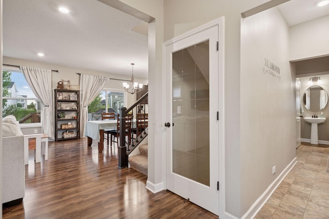 17552 57th St NE, Otsego, MN 55374 - hall featuring a chandelier, stairs, wood finished floors, and recessed lighting