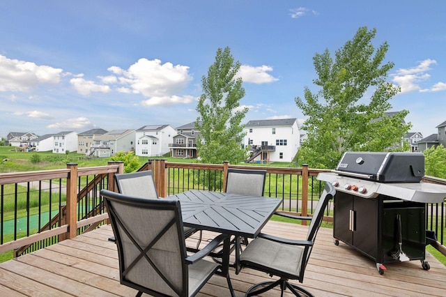 17552 57th St NE, Otsego, MN 55374 - wooden terrace with a residential view, outdoor dining space, grilling area, and a lawn