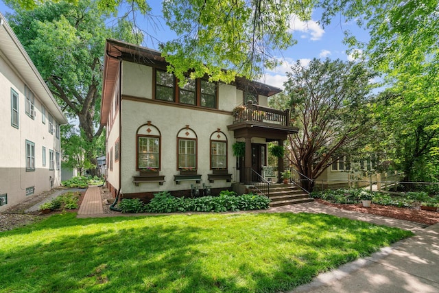 952 Goodrich Ave, Saint Paul, MN 55105 - view of front facade with a balcony, a front lawn, and stucco siding