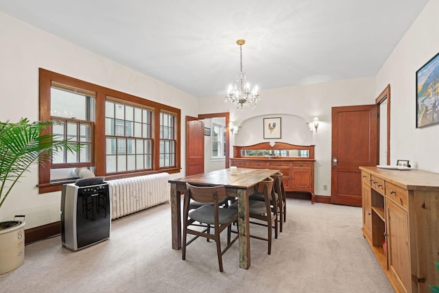 952 Goodrich Ave, Saint Paul, MN 55105 - dining area with radiator, light colored carpet, and a chandelier