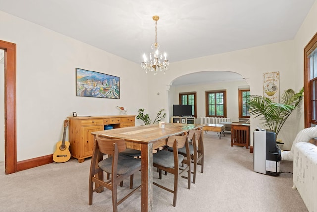 952 Goodrich Ave, Saint Paul, MN 55105 - dining space with arched walkways, light carpet, a chandelier, and healthy amount of natural light