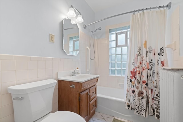 952 Goodrich Ave, Saint Paul, MN 55105 - bathroom featuring radiator heating unit, tile walls, shower / bath combo, vanity, and tile patterned floors