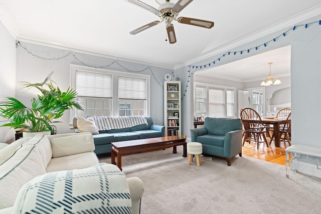 952 Goodrich Ave, Saint Paul, MN 55105 - living area featuring ornamental molding, a chandelier, a ceiling fan, and light colored carpet