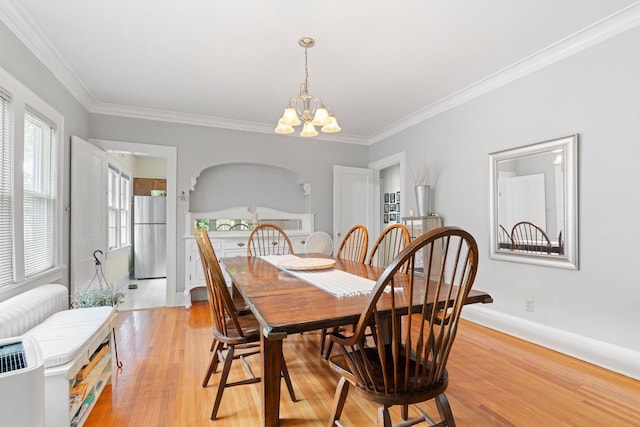 952 Goodrich Ave, Saint Paul, MN 55105 - dining space featuring a chandelier, light wood-style floors, and crown molding