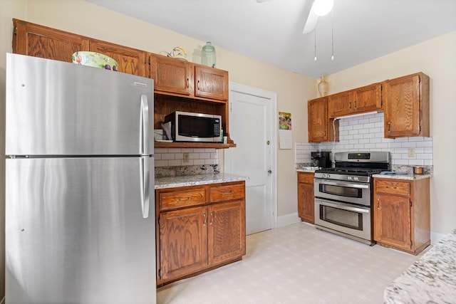 952 Goodrich Ave, Saint Paul, MN 55105 - kitchen with appliances with stainless steel finishes, tasteful backsplash, brown cabinets, and ceiling fan