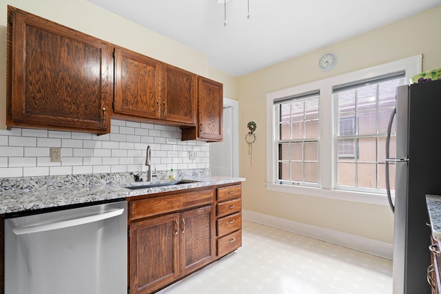 952 Goodrich Ave, Saint Paul, MN 55105 - kitchen with stainless steel appliances, tasteful backsplash, light flooring, and light stone countertops