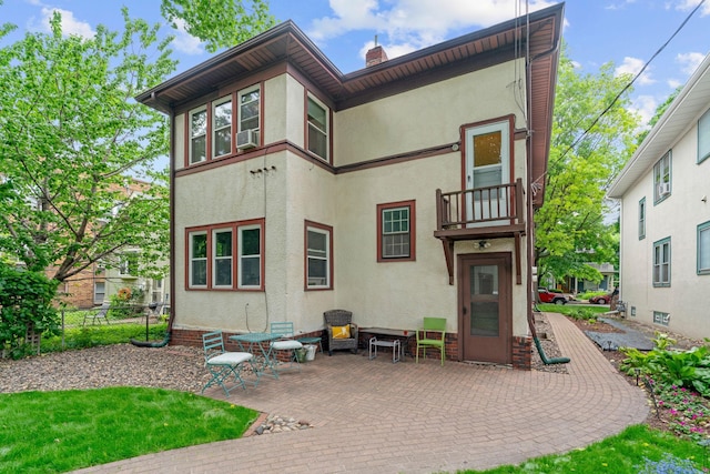 952 Goodrich Ave, Saint Paul, MN 55105 - rear view of property featuring a patio area, stucco siding, a balcony, and a chimney