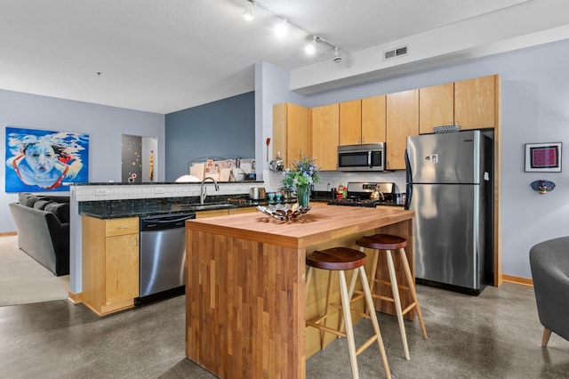 2650 University Ave W Unit 1, Saint Paul, MN 55114 - kitchen with stainless steel appliances, wooden counters, a peninsula, concrete floors, and decorative backsplash