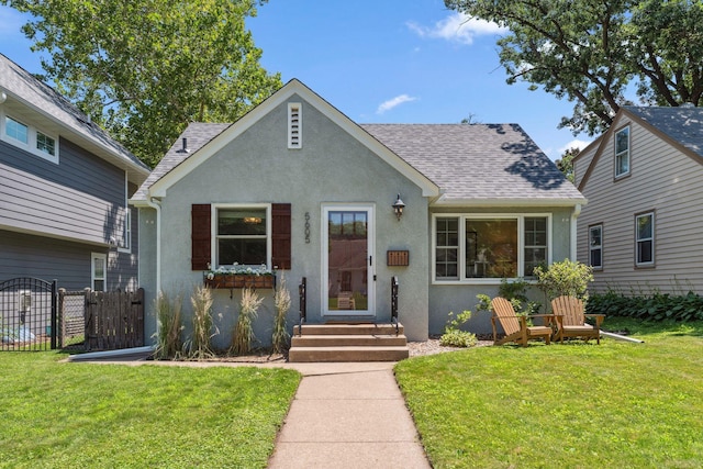 5605 Logan Ave S, Minneapolis, MN 55419 - tudor house with stucco siding, roof with shingles, and a gate