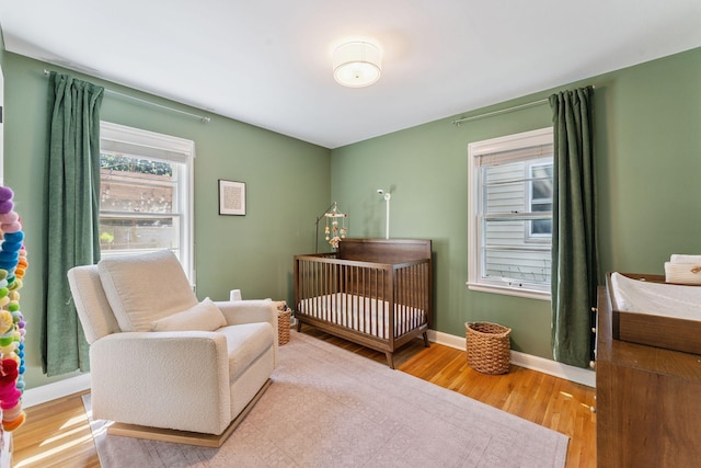 5605 Logan Ave S, Minneapolis, MN 55419 - bedroom featuring wood finished floors and a nursery area