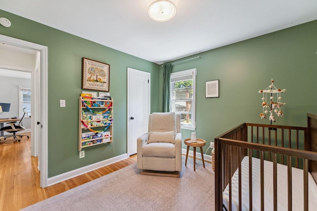 5605 Logan Ave S, Minneapolis, MN 55419 - bedroom featuring a desk, wood finished floors, and a crib