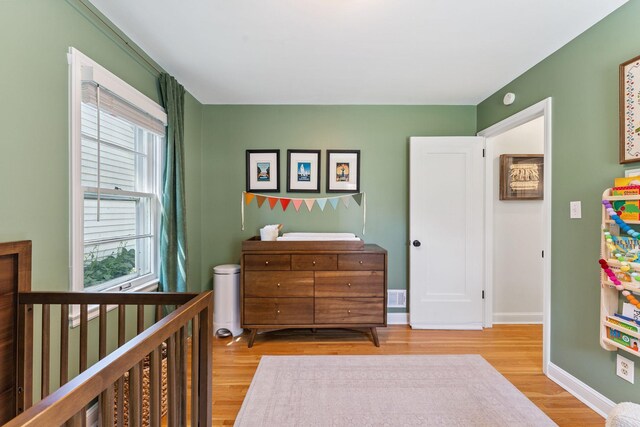 5605 Logan Ave S, Minneapolis, MN 55419 - bedroom featuring light wood-style floors and a crib