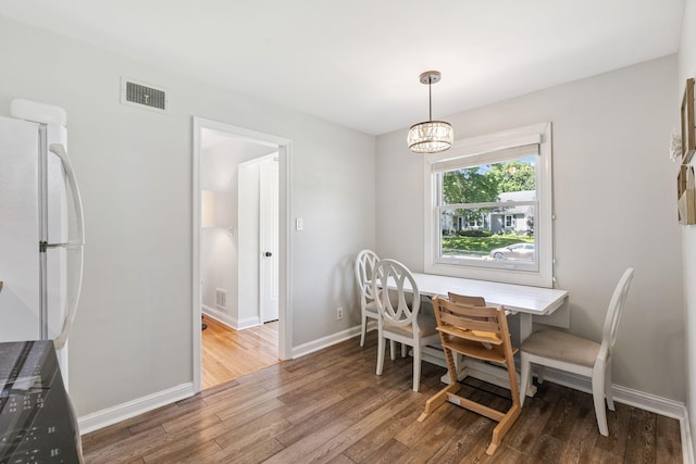 5605 Logan Ave S, Minneapolis, MN 55419 - dining room featuring wood finished floors and a chandelier