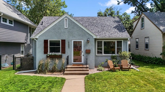 5605 Logan Ave S, Minneapolis, MN 55419 - view of front facade featuring stucco siding, a shingled roof, and a gate