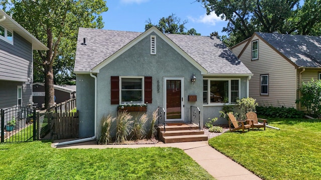 5605 Logan Ave S, Minneapolis, MN 55419 - view of front facade featuring stucco siding, roof with shingles, and a gate