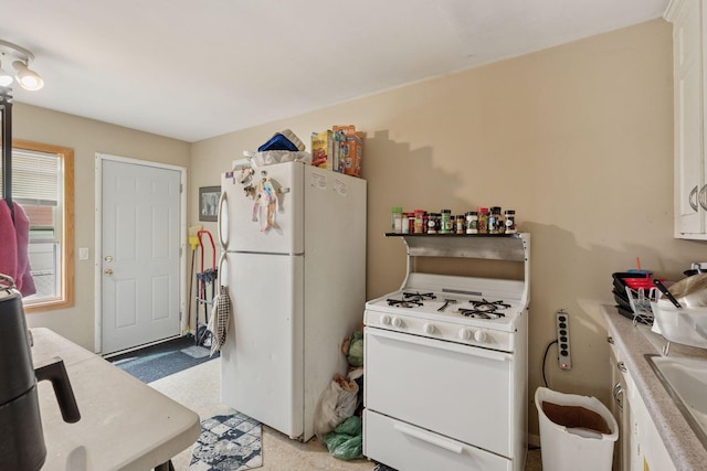 3810 Regent Ave N, Robbinsdale, MN 55422 - kitchen with white appliances and light countertops