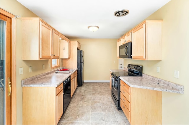 1229 Arrowhead Rd, Duluth, MN 55811 - kitchen featuring black appliances, light brown cabinets, and light countertops