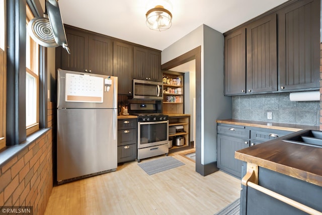 5116 28th Ave S, Minneapolis, MN 55417 - kitchen with stainless steel appliances, light wood-type flooring, decorative backsplash, open shelves, and dark brown cabinetry