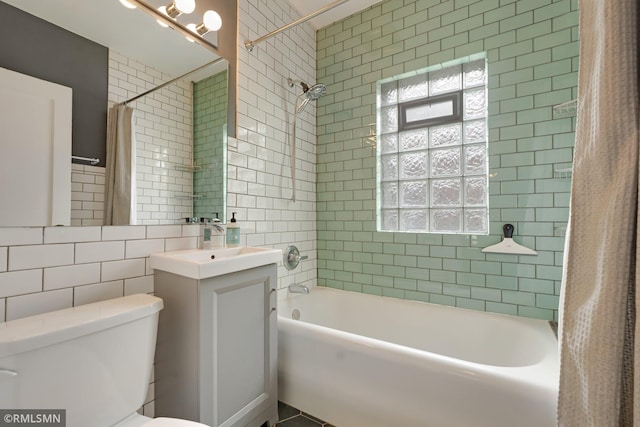 5116 28th Ave S, Minneapolis, MN 55417 - bathroom featuring shower / bathtub combination with curtain, tile walls, vanity, and toilet