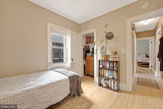 5116 28th Ave S, Minneapolis, MN 55417 - bedroom with light wood finished floors, a closet, and baseboards