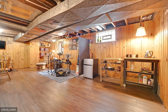 5116 28th Ave S, Minneapolis, MN 55417 - below grade area featuring freestanding refrigerator, wood walls, and wood finished floors