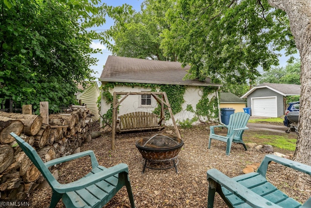 5116 28th Ave S, Minneapolis, MN 55417 - view of patio with a fire pit, an outdoor structure, and a garage