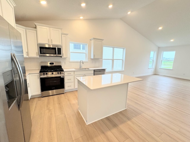 7031 Lannon Ave NE, Otsego, MN 55301 - kitchen featuring appliances with stainless steel finishes, backsplash, light wood-type flooring, light countertops, and white cabinets