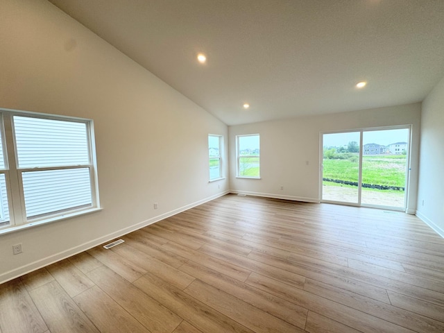 7031 Lannon Ave NE, Otsego, MN 55301 - unfurnished room featuring wood finished floors, recessed lighting, and vaulted ceiling