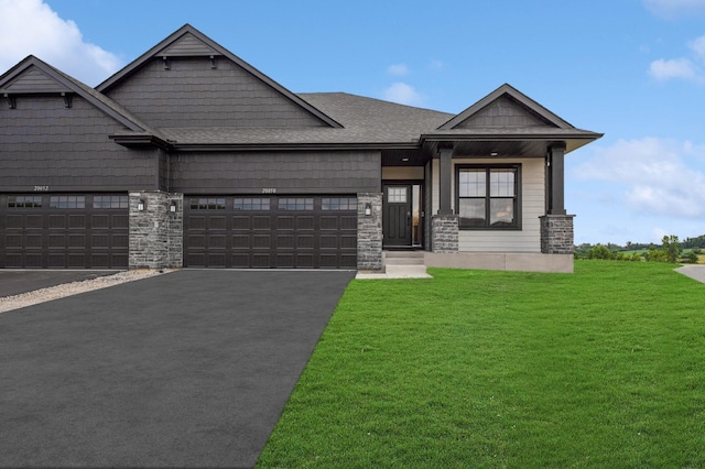 20050 66th Pl, Corcoran, MN 55340 - craftsman house featuring a front lawn, an attached garage, asphalt driveway, and stone siding