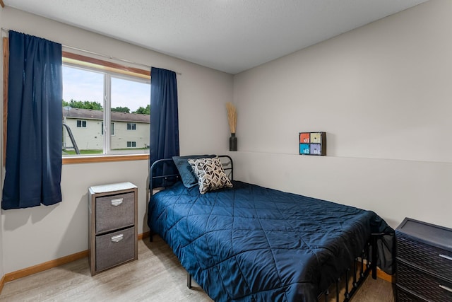 920 Lincoln Ct S, Cambridge, MN 55008 - bedroom with wood finished floors and a textured ceiling