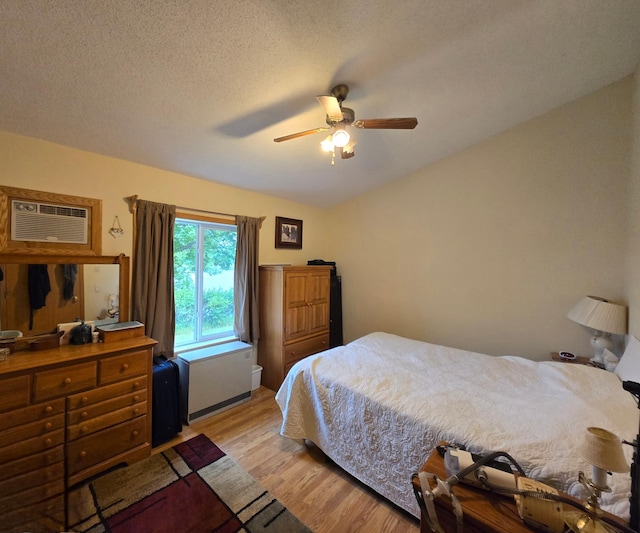35163 Rose Lake Dr, Frazee, MN 56544 - bedroom with light wood finished floors, a wall mounted air conditioner, and a ceiling fan