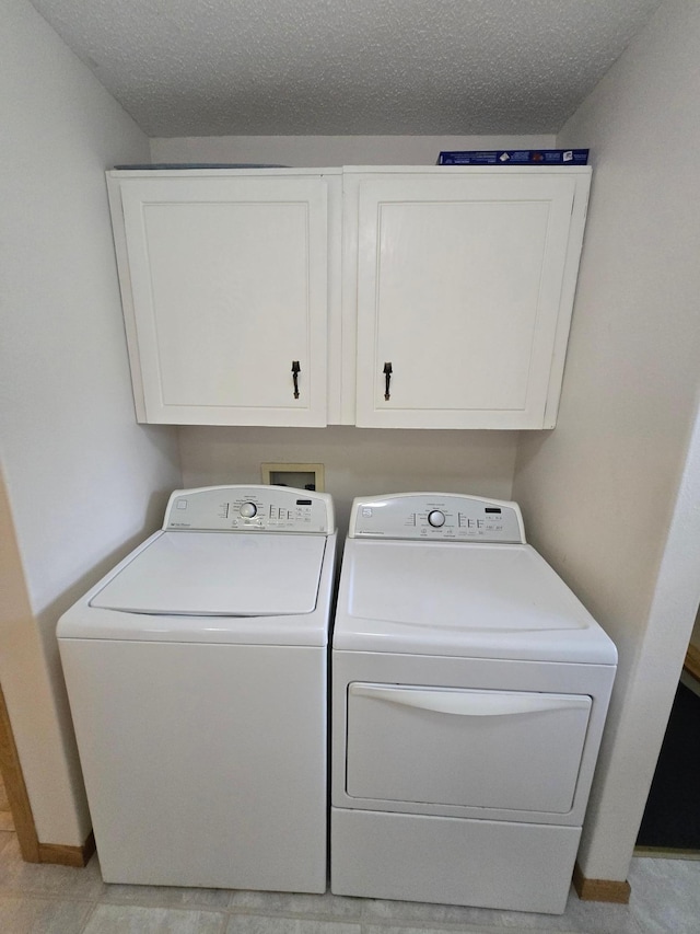 35163 Rose Lake Dr, Frazee, MN 56544 - laundry area featuring separate washer and dryer, cabinet space, and a textured ceiling