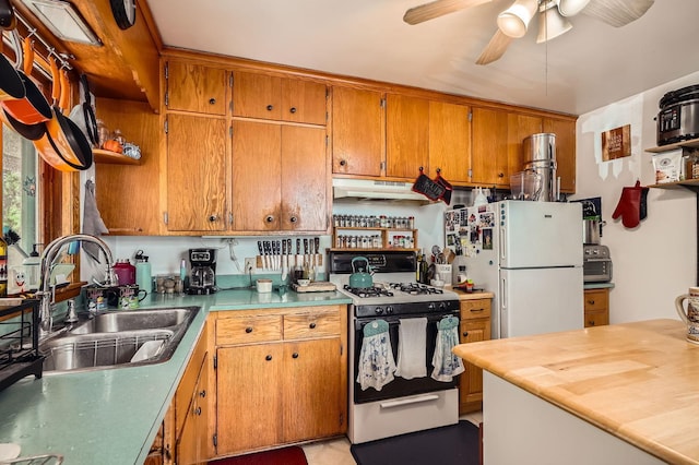 2226 S Ave E, North Saint Paul, MN 55109 - kitchen featuring gas range oven, freestanding refrigerator, under cabinet range hood, ceiling fan, and brown cabinetry