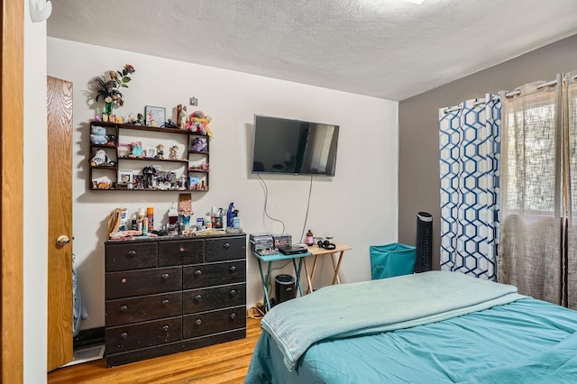 2226 S Ave E, North Saint Paul, MN 55109 - bedroom featuring wood finished floors and a textured ceiling